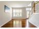 Welcoming foyer featuring hardwood floors and a staircase at 6527 Briarwood Pl, Zionsville, IN 46077