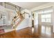 Inviting foyer featuring hardwood floors and a staircase at 6527 Briarwood Pl, Zionsville, IN 46077