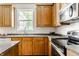 Well-lit kitchen featuring wood cabinets and modern stainless steel appliances at 6527 Briarwood Pl, Zionsville, IN 46077