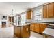 Charming kitchen featuring wood cabinets, granite countertops, and an island with natural light at 6527 Briarwood Pl, Zionsville, IN 46077