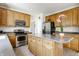 Spacious kitchen with stainless appliances, lots of wood cabinets, and a center island for meal prep at 6527 Briarwood Pl, Zionsville, IN 46077