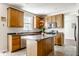 Bright kitchen with oak cabinets, a center island, and stainless steel appliances at 6527 Briarwood Pl, Zionsville, IN 46077