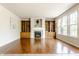 Cozy living room featuring a fireplace, built-in shelving, and hardwood floors at 6527 Briarwood Pl, Zionsville, IN 46077