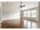 Spacious living room with vaulted ceiling, fan, and windows providing ample natural light at 6527 Briarwood Pl, Zionsville, IN 46077