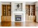 Cozy living room featuring a fireplace with tile surround and built-in cabinets at 6527 Briarwood Pl, Zionsville, IN 46077