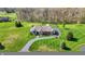 Aerial view of home featuring well-manicured lawn, mature landscaping, and inviting circular driveway at 6829 Whitetail Woods Ct, Bargersville, IN 46106