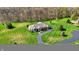 Sprawling one-story home with beautiful landscaping, a circular driveway, and mature trees at 6829 Whitetail Woods Ct, Bargersville, IN 46106