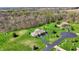 Lush greenery surrounds the beautiful home with long driveway and mature trees at 6829 Whitetail Woods Ct, Bargersville, IN 46106