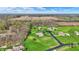 Aerial view showing multiple homes with expansive lawns, set against a backdrop of trees and fields at 6829 Whitetail Woods Ct, Bargersville, IN 46106