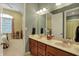 Bathroom features double vanity and large mirror with access to the bedroom at 6829 Whitetail Woods Ct, Bargersville, IN 46106