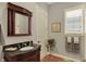 Bathroom with traditional vanity, framed mirror, and window with natural light at 6829 Whitetail Woods Ct, Bargersville, IN 46106