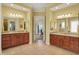 A well-lit bathroom features dual vanities with granite countertops and a connecting doorway at 6829 Whitetail Woods Ct, Bargersville, IN 46106