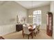 Elegant dining room featuring neutral tones, wainscoting, and a modern chandelier at 6829 Whitetail Woods Ct, Bargersville, IN 46106