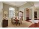 A dining room featuring wainscoting, a dark wood table, and a decorative china cabinet at 6829 Whitetail Woods Ct, Bargersville, IN 46106