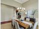 Dining room with neutral colors, wainscoting, and a modern chandelier overlooking the living room at 6829 Whitetail Woods Ct, Bargersville, IN 46106