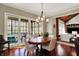 Dining room featuring a stylish chandelier, hardwood floors, and access to the patio at 6829 Whitetail Woods Ct, Bargersville, IN 46106
