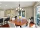 This dining room features an elegant chandelier, hardwood floors, and access to the kitchen at 6829 Whitetail Woods Ct, Bargersville, IN 46106
