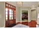 Inviting foyer with hardwood floors, stylish chandelier, and view to office at 6829 Whitetail Woods Ct, Bargersville, IN 46106