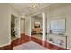 Open foyer with hardwood floors, a view to the living room, and adjacent office at 6829 Whitetail Woods Ct, Bargersville, IN 46106