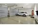 Three car garage with epoxy floors, garage door openers, and a white Lexus RX at 6829 Whitetail Woods Ct, Bargersville, IN 46106