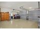 Spacious three car garage with epoxy floors, cabinets, and a red Polaris ATV at 6829 Whitetail Woods Ct, Bargersville, IN 46106