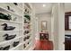 Hallway featuring hardwood floors, custom built-in shelving, and decorative accents at 6829 Whitetail Woods Ct, Bargersville, IN 46106