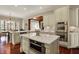 Elegant kitchen boasts custom cabinets, stainless appliances, and a large center island with microwave oven at 6829 Whitetail Woods Ct, Bargersville, IN 46106