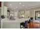 This spacious kitchen features a large island, custom cabinets, and granite countertops with barstool seating at 6829 Whitetail Woods Ct, Bargersville, IN 46106