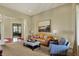 Inviting living room boasts a leather sofa, plush armchair, and neutral decor at 6829 Whitetail Woods Ct, Bargersville, IN 46106