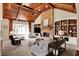 Vaulted living room featuring a stone fireplace, wood ceiling, and built-in shelving at 6829 Whitetail Woods Ct, Bargersville, IN 46106