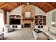 Bright living room features a stone fireplace, built-in shelving, and vaulted ceilings at 6829 Whitetail Woods Ct, Bargersville, IN 46106