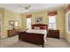 Spacious main bedroom with neutral carpet and dark wood furniture at 6829 Whitetail Woods Ct, Bargersville, IN 46106