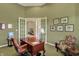 Comfortable home office boasts wooden desk and a sitting area at 6829 Whitetail Woods Ct, Bargersville, IN 46106