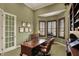 A bright home office with dark trim, built-ins and rich wood desk at 6829 Whitetail Woods Ct, Bargersville, IN 46106
