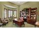 Office with custom built-in shelving, wood desk, and window views at 6829 Whitetail Woods Ct, Bargersville, IN 46106