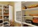 Organized pantry featuring white shelving for ample storage, and a window for natural light at 6829 Whitetail Woods Ct, Bargersville, IN 46106