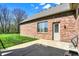 Brick home features a patio and view to backyard and wooded area at 6829 Whitetail Woods Ct, Bargersville, IN 46106