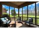 Screened-in porch with seating area overlooking beautiful trees at 6829 Whitetail Woods Ct, Bargersville, IN 46106