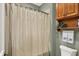 Bathroom showcasing shower with shower curtain, storage shelves, and towel rack at 6829 Whitetail Woods Ct, Bargersville, IN 46106