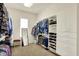 Spacious walk-in closet with custom shelving, hanging rods, and a mirror at 6829 Whitetail Woods Ct, Bargersville, IN 46106