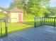 Backyard featuring a deck and shed, surrounded by lush greenery and a serene atmosphere at 7108 Hearthstone Way, Indianapolis, IN 46227