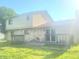 Exterior features stone details, large backyard, and wooden deck perfect for outdoor relaxation at 7108 Hearthstone Way, Indianapolis, IN 46227