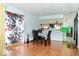 Comfortable dining area with hardwood floors and view to the kitchen, creating a perfect space for meals at 7108 Hearthstone Way, Indianapolis, IN 46227
