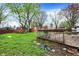 Large backyard with a wooden deck, perfect for outdoor entertaining at 7212 E Pleasant Run Pkwy S Dr, Indianapolis, IN 46219
