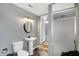 Small bathroom with pedestal sink and standing shower at 7212 E Pleasant Run Pkwy S Dr, Indianapolis, IN 46219