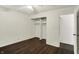 Bedroom features a large closet, ceiling fan and dark wood floors at 7212 E Pleasant Run Pkwy S Dr, Indianapolis, IN 46219