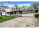 Single-story house with a two-car garage and a long driveway at 7212 E Pleasant Run Pkwy S Dr, Indianapolis, IN 46219