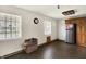 Bright kitchen features wood floors, stainless steel refrigerator, white walls, and wooden cabinets at 7212 E Pleasant Run Pkwy S Dr, Indianapolis, IN 46219