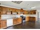 Eat-in kitchen featuring oak cabinets, stainless steel appliances, and tile countertops at 7212 E Pleasant Run Pkwy S Dr, Indianapolis, IN 46219