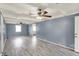 Large living room features wood floors, ceiling fans, and access to multiple rooms at 7212 E Pleasant Run Pkwy S Dr, Indianapolis, IN 46219